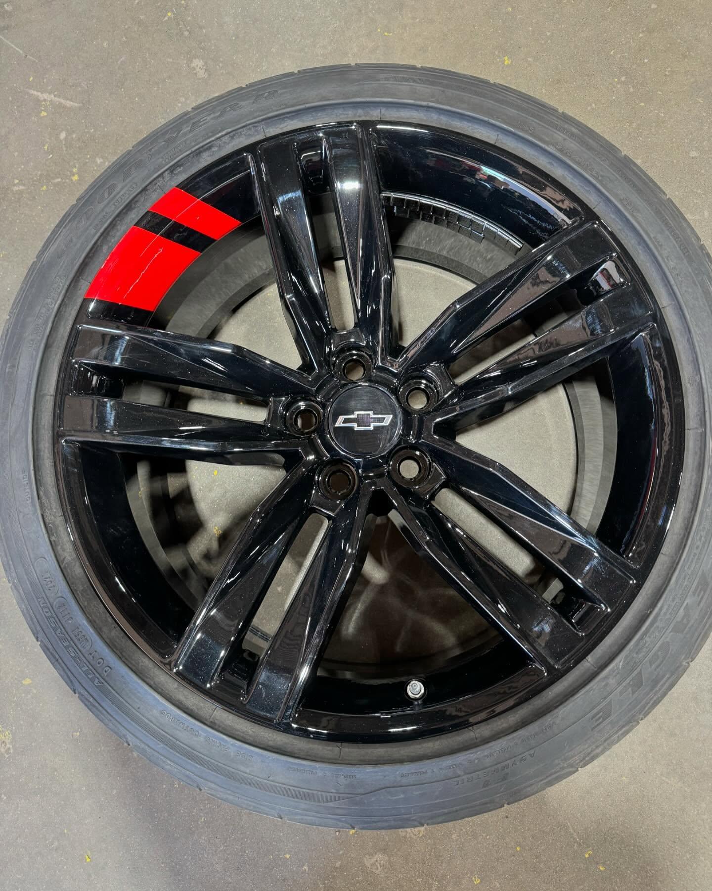 Camaro wheel after a gloss black refinish at the Ferndale shop